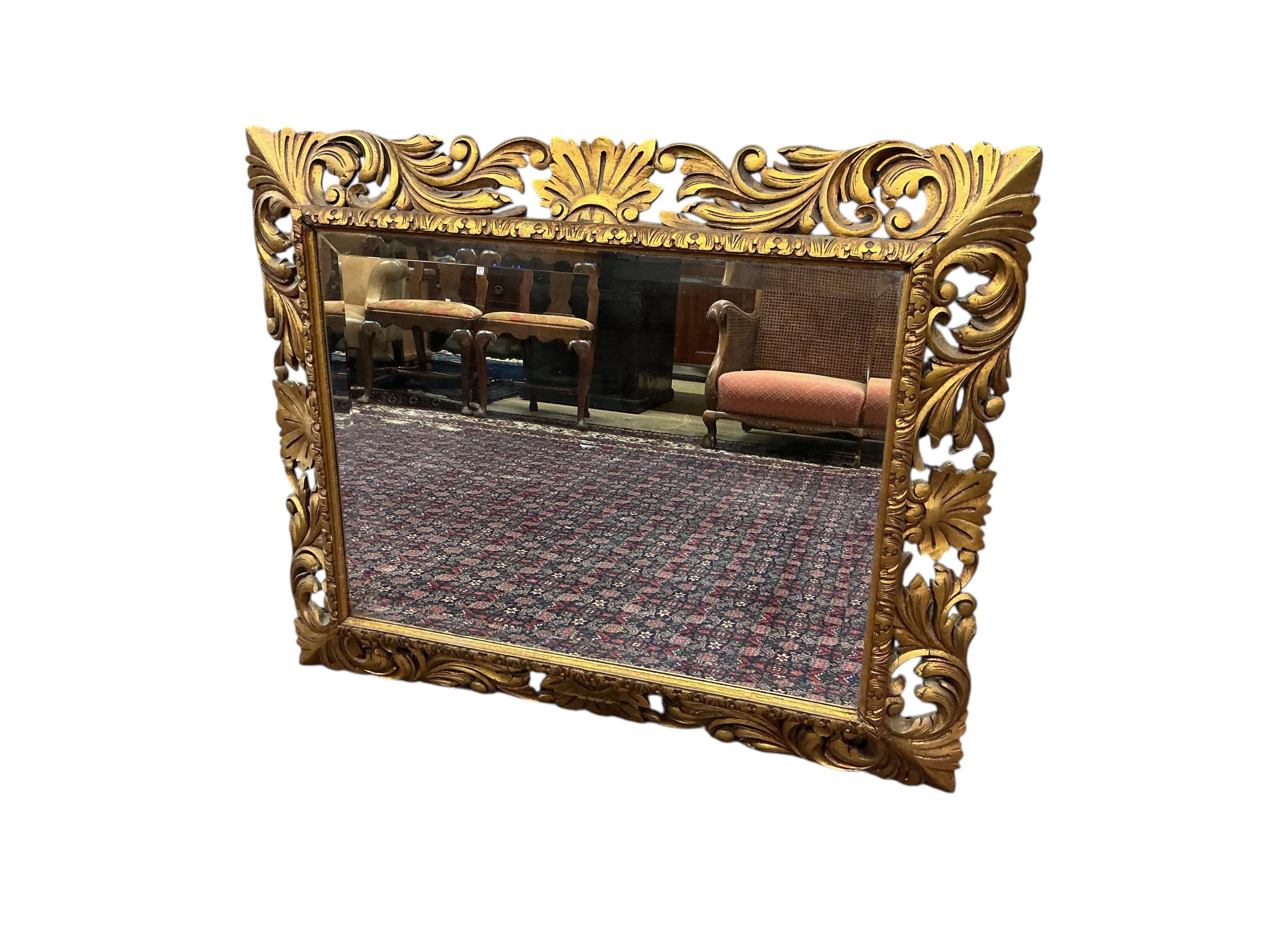 A rectangular carved giltwood Florentine style wall mirror with bevelled plate, width 110cm, height 90cm